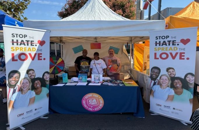 A Stop the Hate (STH) media and information booth at the Taste of Soul Festival in Crenshaw, California in October 2024. Now, ethnic media statewide face an end to STH funding, while hate crimes in California have dramatically risen. (Courtesy: California Office of Civil Rights and California Black Media)