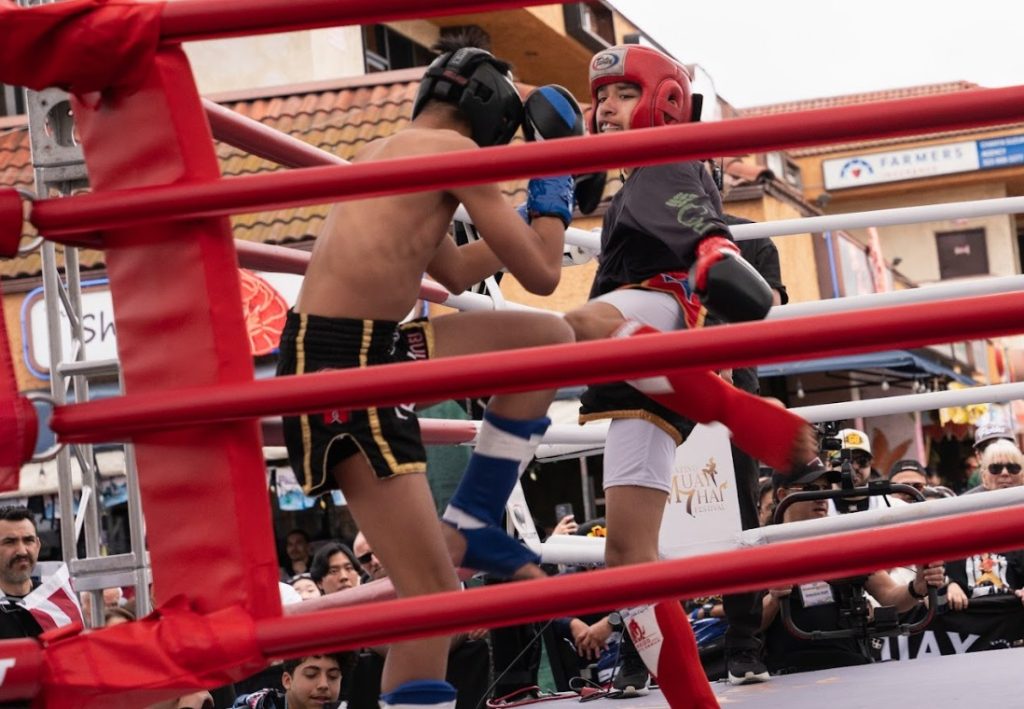 Eli Olario (left) and Eduardo “The Ninja” Rieto (right) fight in a strawweight match at Thai New Year Songkran Festival in Thai Town 2025