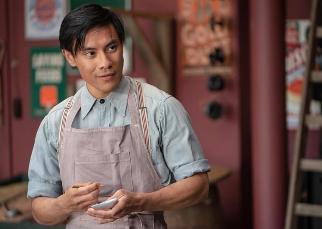 Yao in Sinners wearing overalls in a store.