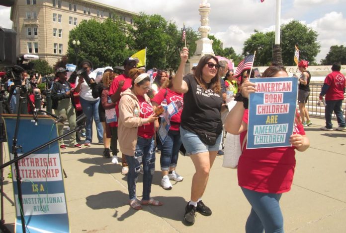 Demonstrators march around the Supreme Court in favor of birthright citizenship