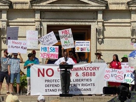 Ohio State Sen Hearcel Craig speaks against SB88 and HB1 in front of the State Capitol building in Ohio.